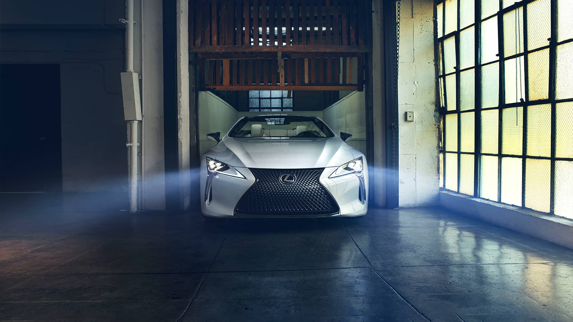 The Lexus LC 500 with headlights on.